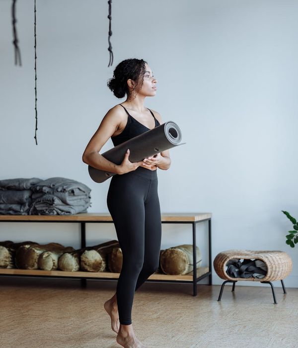 Woman holding a calm yoga pose in a bright studio.